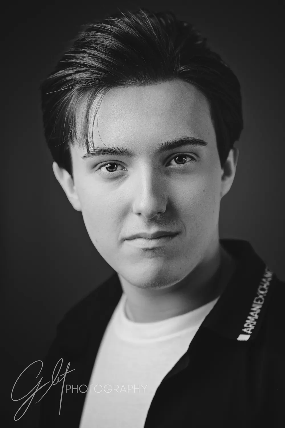 A calm, well-rested black-and-white headshot — quiet confidence straight into the lens