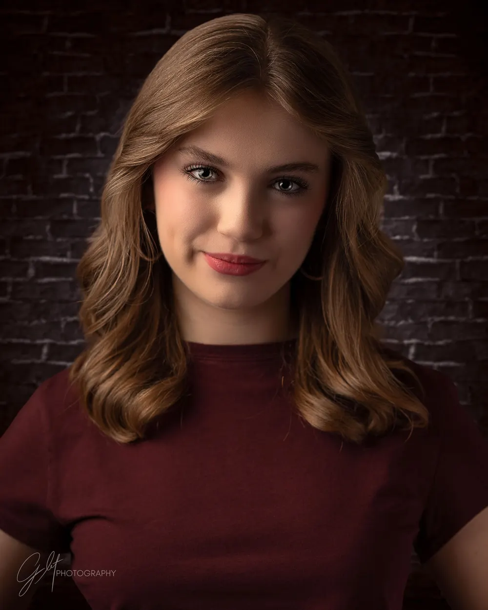 A character-forward look against a brick wall — same performer, a completely different casting energy