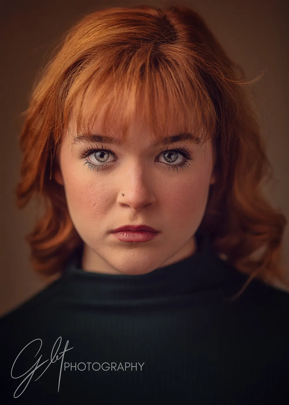 A serious, direct portrait — the dramatic story, settled and confident