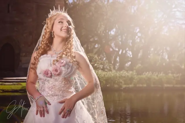 A bride-of-the-swamp fantasy character in a veil and crown, golden light