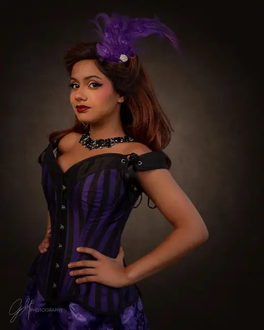 Costumed character portrait in a violet corset and plumed headpiece