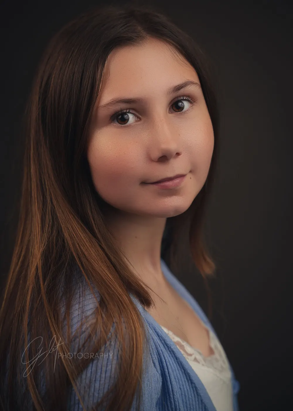 A delivered portrait — soft, warm studio light and an easy expression