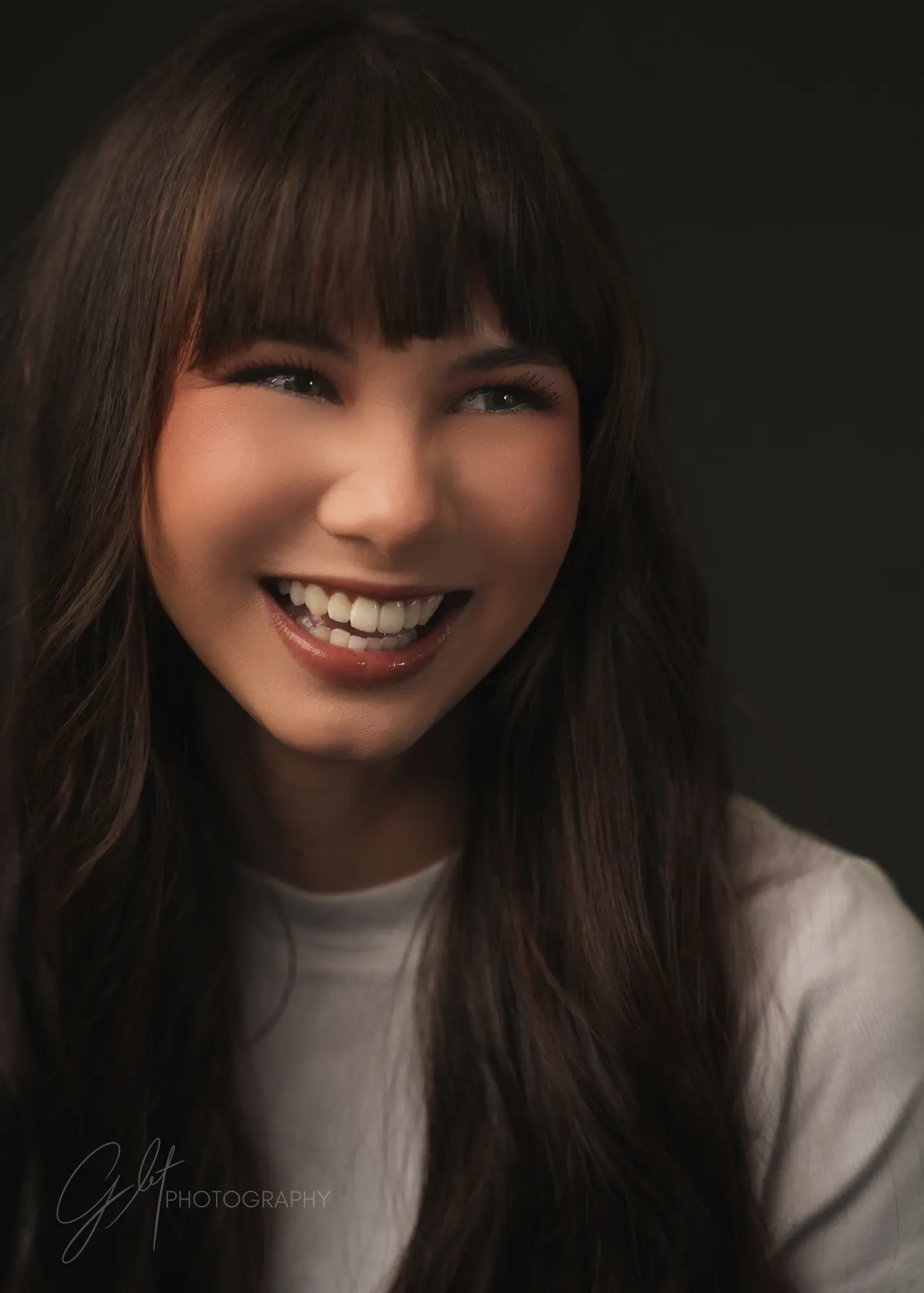 The same woman breaking into a wide smile