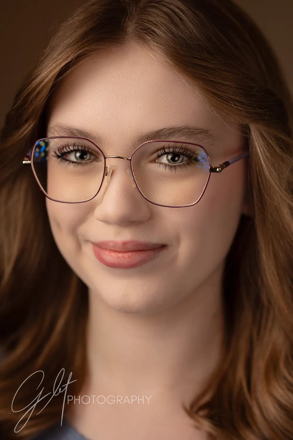 A performer in her everyday glasses — a headshot that will match the person who walks into the audition