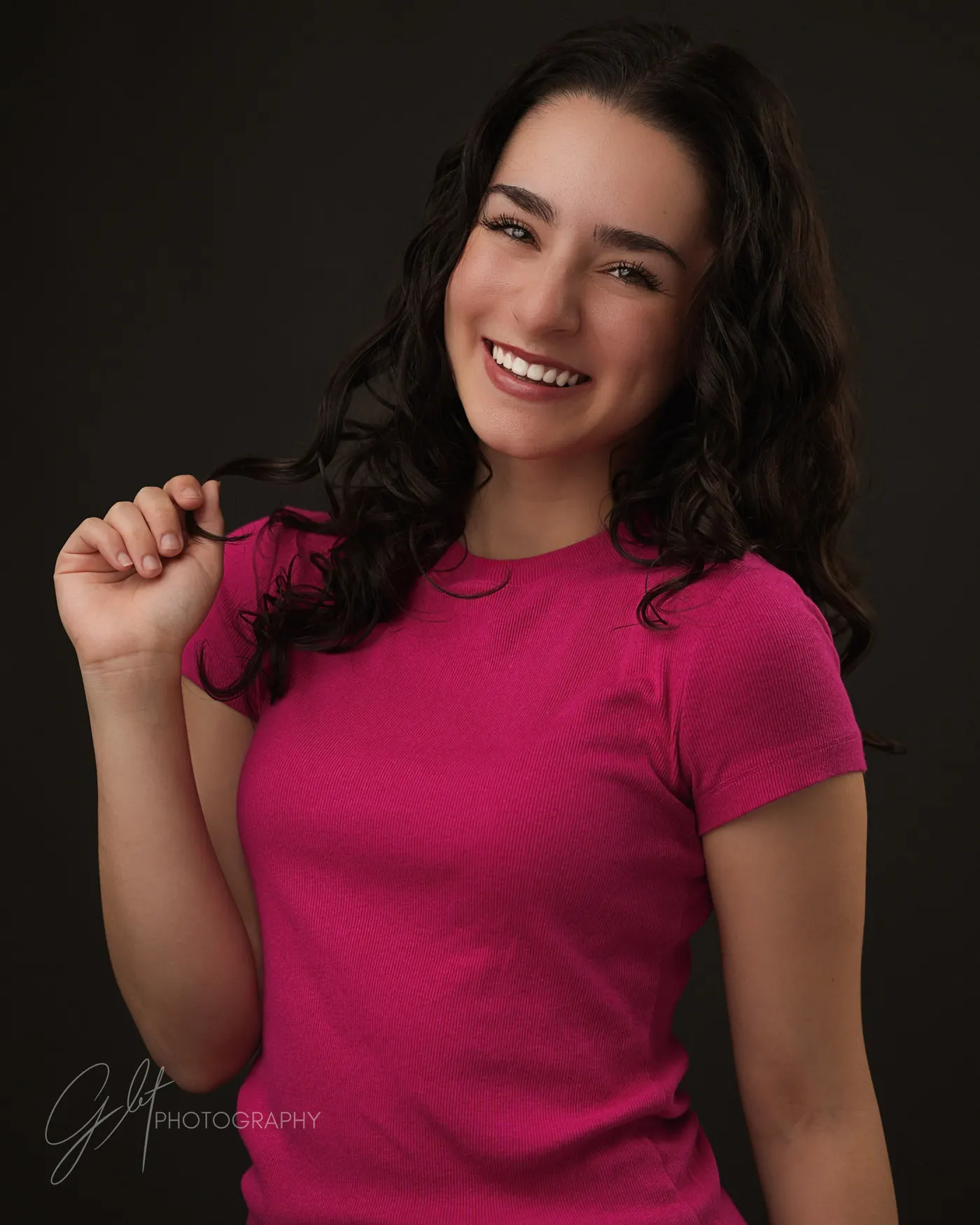 A bold pink tee worn simply