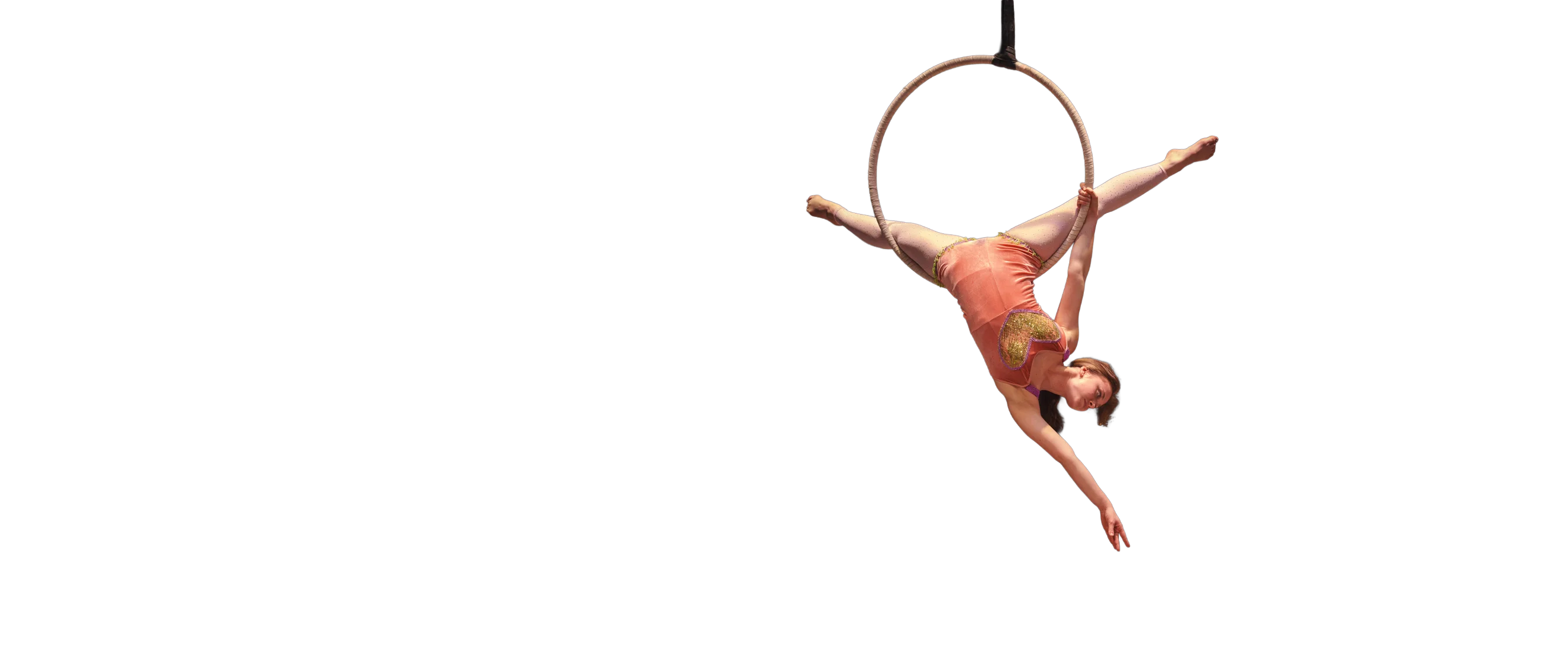 An aerial hoop performer suspended mid-act above an empty stage, photographed live in Lakeland FL